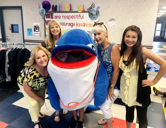 staff members with the Dolphin mascot